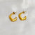 Golden clutch hoops earrings
